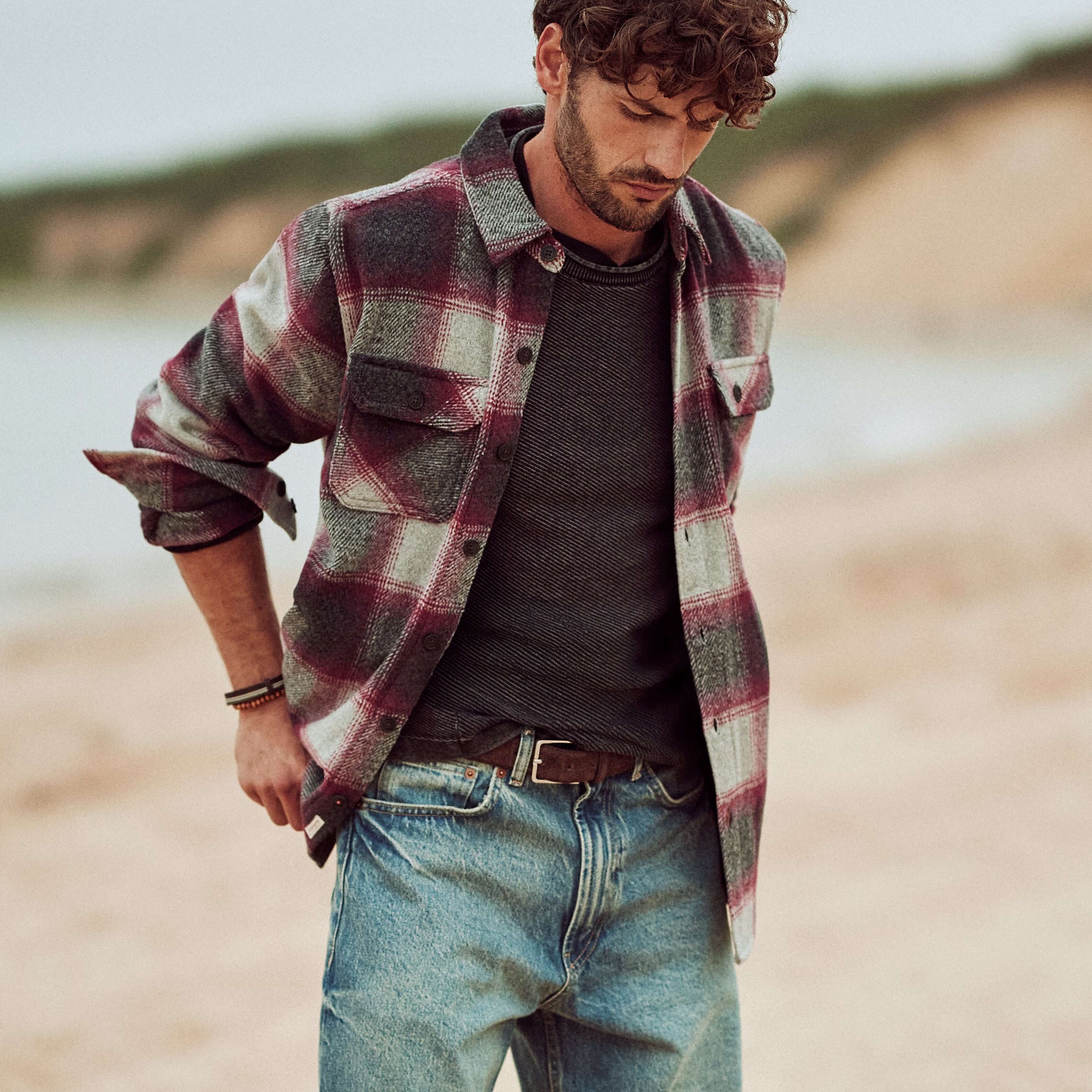 Brushed Unlined Shirt Jacket in Burgundy worn by a model on the beach, styled with a gray shirt and relaxed jeans.