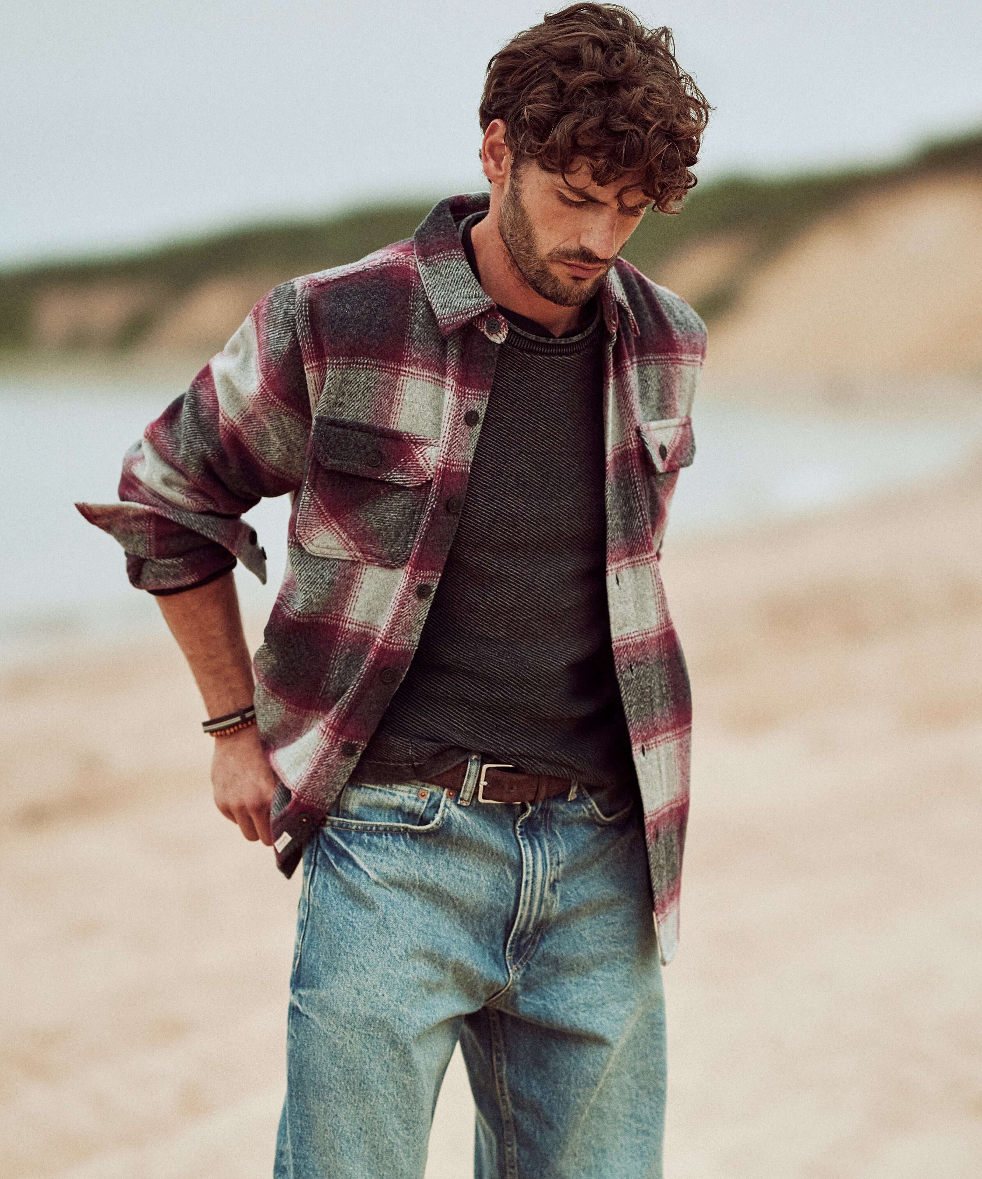Brushed Unlined Shirt Jacket in Burgundy worn by a model on the beach, styled with a gray shirt and relaxed jeans.