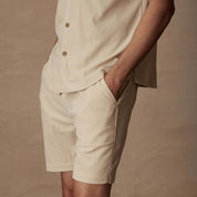 6" Cream Corduroy Cabana Shorts featuring side pockets and adjustable drawstring, styled for comfort and versatility.