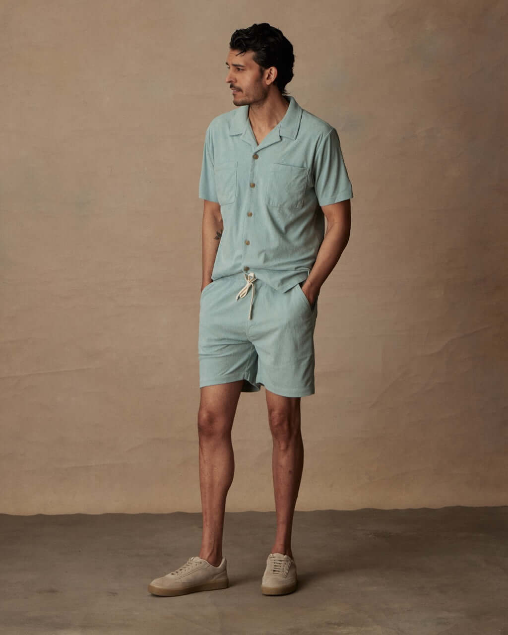 Model wearing 6" Corduroy Cabana Short in Teal Mist, styled with matching shirt and casual sneakers.