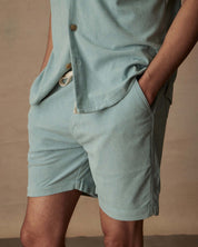 Model showcases 6" corduroy cabana shorts in teal mist, featuring a stretch waistband and side pockets.