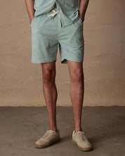 Model in teal mist 6" corduroy cabana shorts, paired with neutral sneakers, showcasing a classic fit and adjustable drawstring.