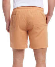 Back view of 7" linen shorts in Biscuit color with elastic waistband and side pockets.