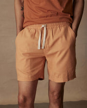 Men's 7" linen shorts in biscuit color with elastic waistband and adjustable drawstring, perfect for casual summer wear.