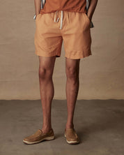 7" linen shorts in biscuit, featuring an elastic waist and adjustable drawcord for comfort.