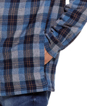 Close-up of the Sherpa Lined Hooded Shirt Jacket In Blue, showcasing the fabric pattern and side pocket.