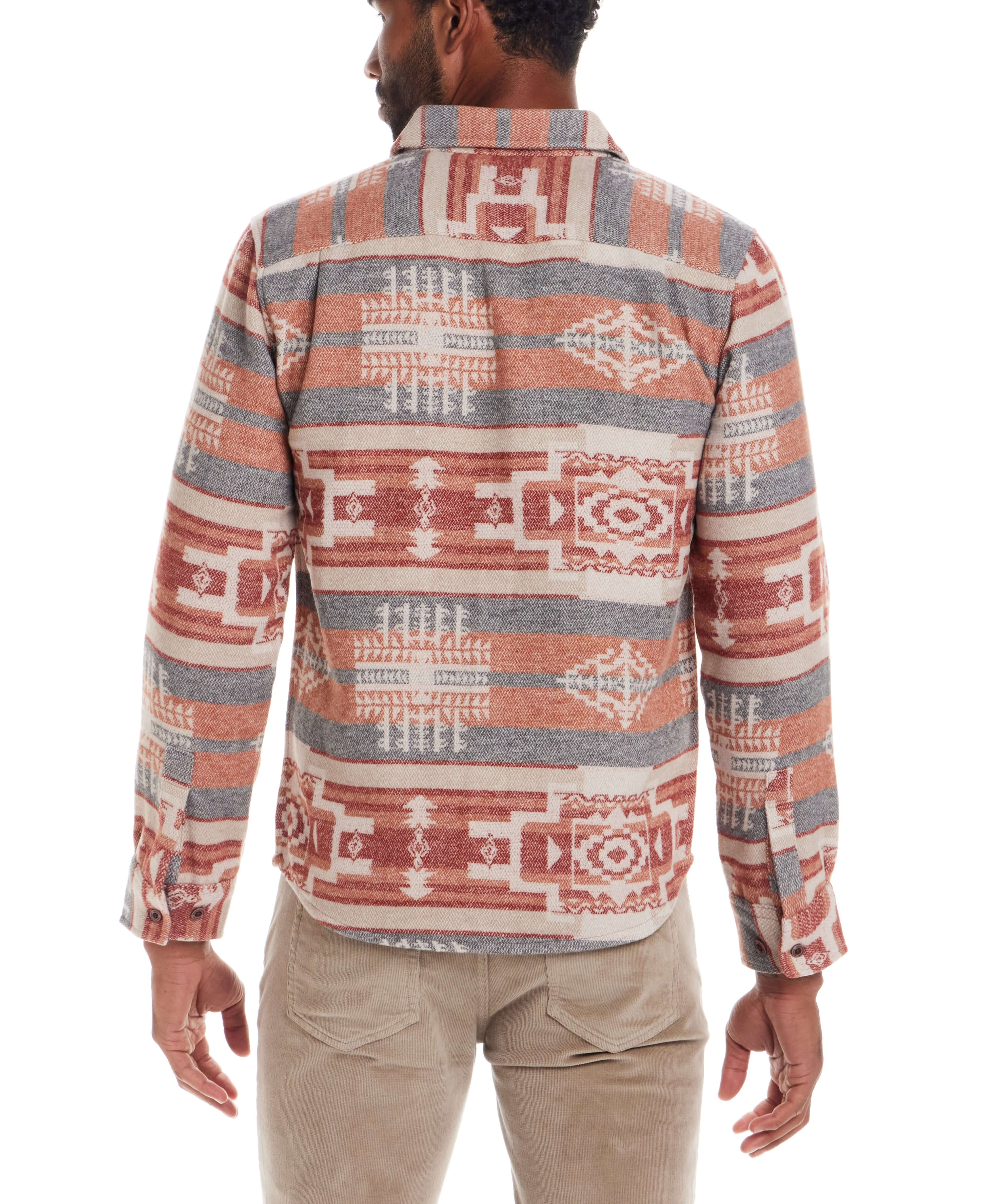 Back view of the Southwest Unlined Shirt Jacket in Rust showcasing its bold woven pattern and chambray details.