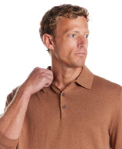 Model wearing a Cotton Cashmere Long Sleeve Polo in Camel, showcasing a refined knit design and classic polo collar.