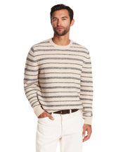 Model wearing a fuzzy striped crew sweater in cream and blue, showcasing a classic yet casual design for cool-weather style.