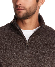 Close-up of a man wearing a fuzzy brown quarter zip sweater with a mock neck and ribbed cuffs.