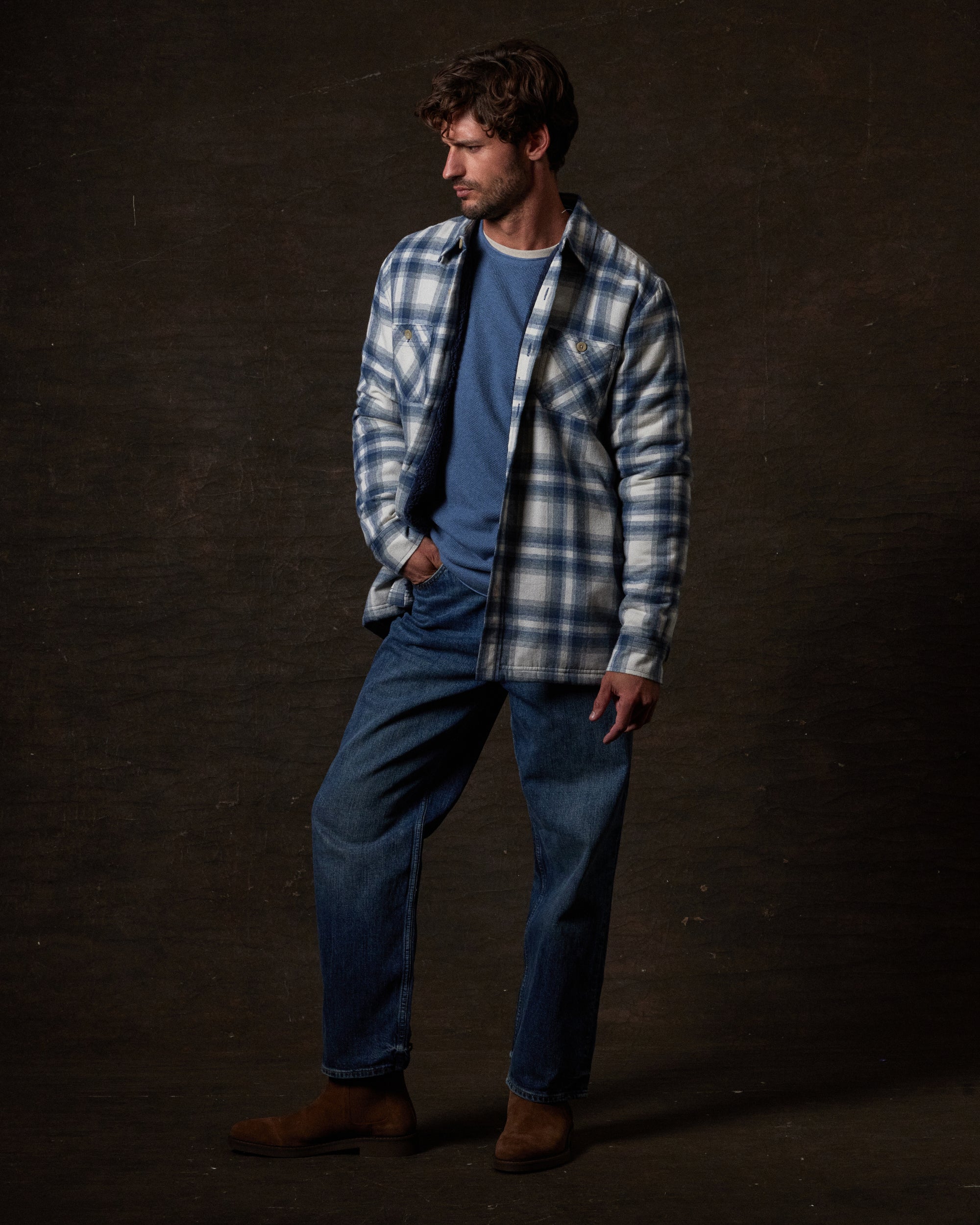 Sherpa Lined Flannel Shirt Jacket in Iron Blue worn by a model with a relaxed fit over a blue shirt and jeans.
