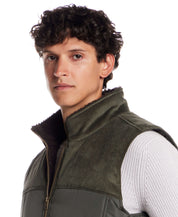 Sherpa Lined Mixed Media Puffer Vest in Kambaba Olive worn by a man, showcasing the stylish and warm design.