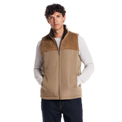Sherpa Lined Mixed Media Puffer Vest in Kangaroo worn by a model, featuring corduroy yoke and soft sherpa lining.