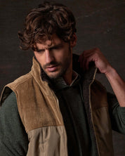 Sherpa Lined Mixed Media Puffer Vest in Kangaroo worn by model, showcasing its corduroy trim and soft sherpa interior.