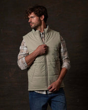 Matte Coated Shell Puffer Vest in Abbey Stone worn by model, showcasing its sleek design and modern utility.