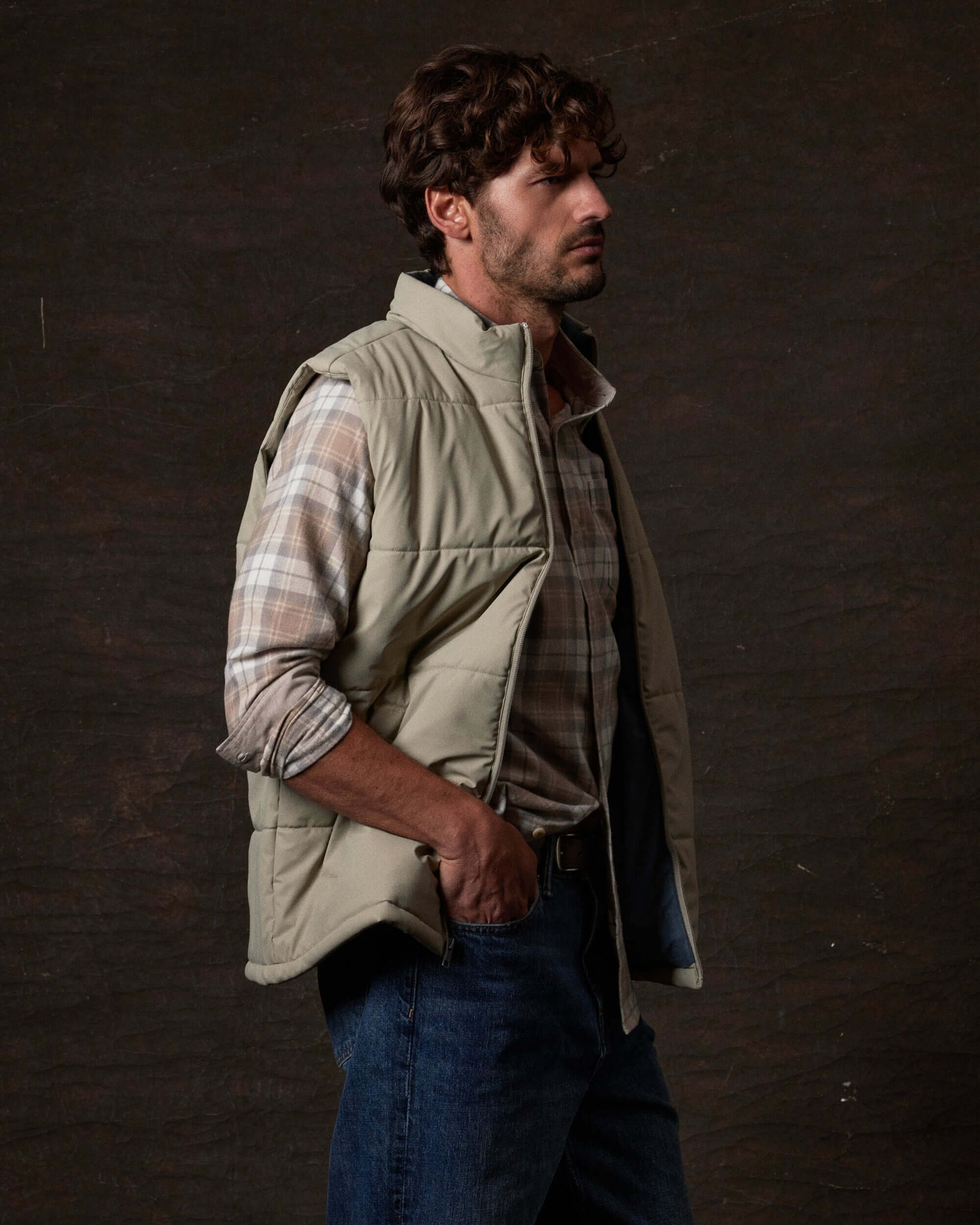 Matte Coated Shell Puffer Vest in Abbey Stone worn by a model, featuring zip-front closure and side pockets.