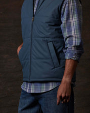 Matte Coated Shell Puffer Vest in Slate Blue worn by a model, showcasing lightweight insulation and modern design.