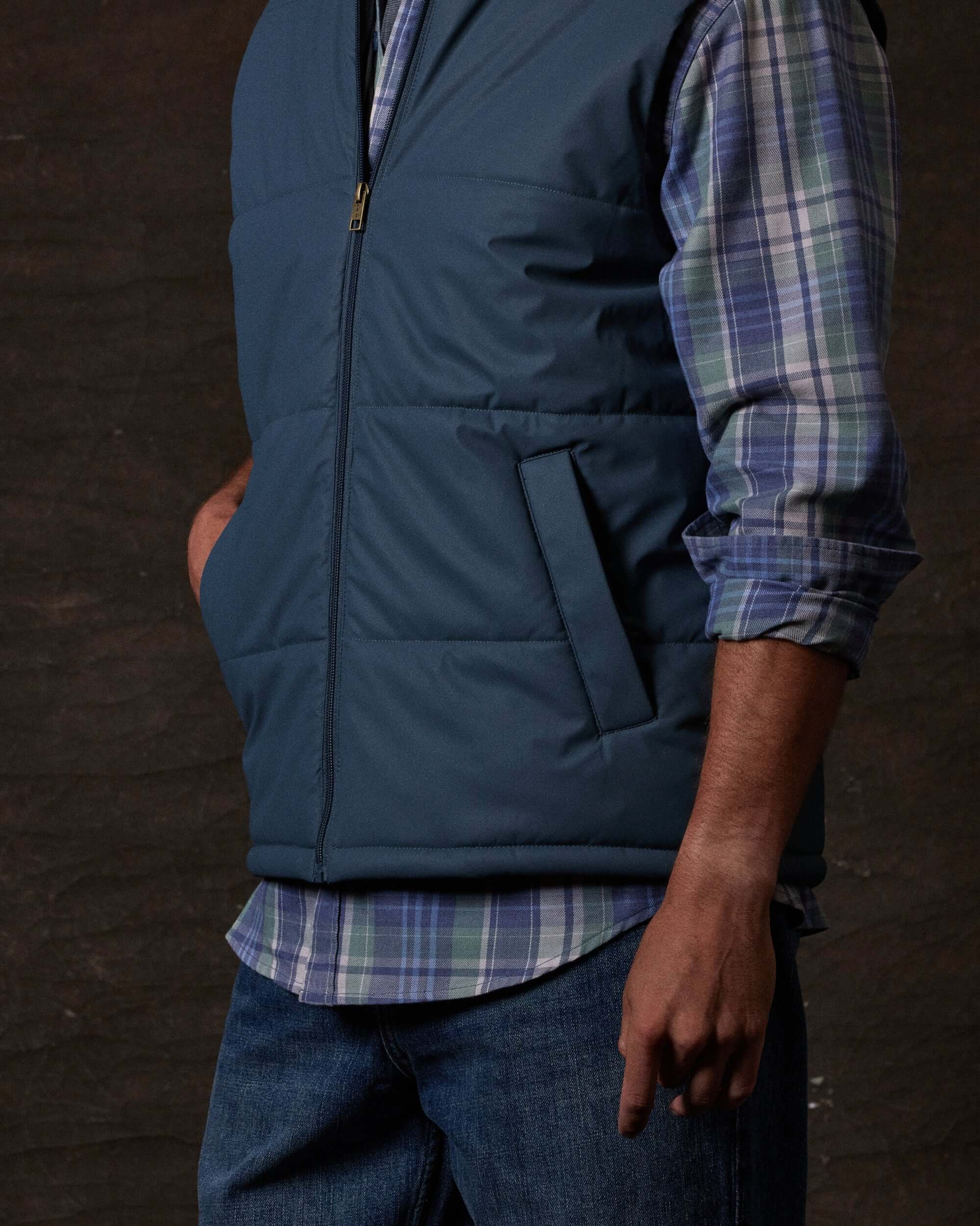 Matte Coated Shell Puffer Vest in Slate Blue worn by a model, showcasing lightweight insulation and modern design.