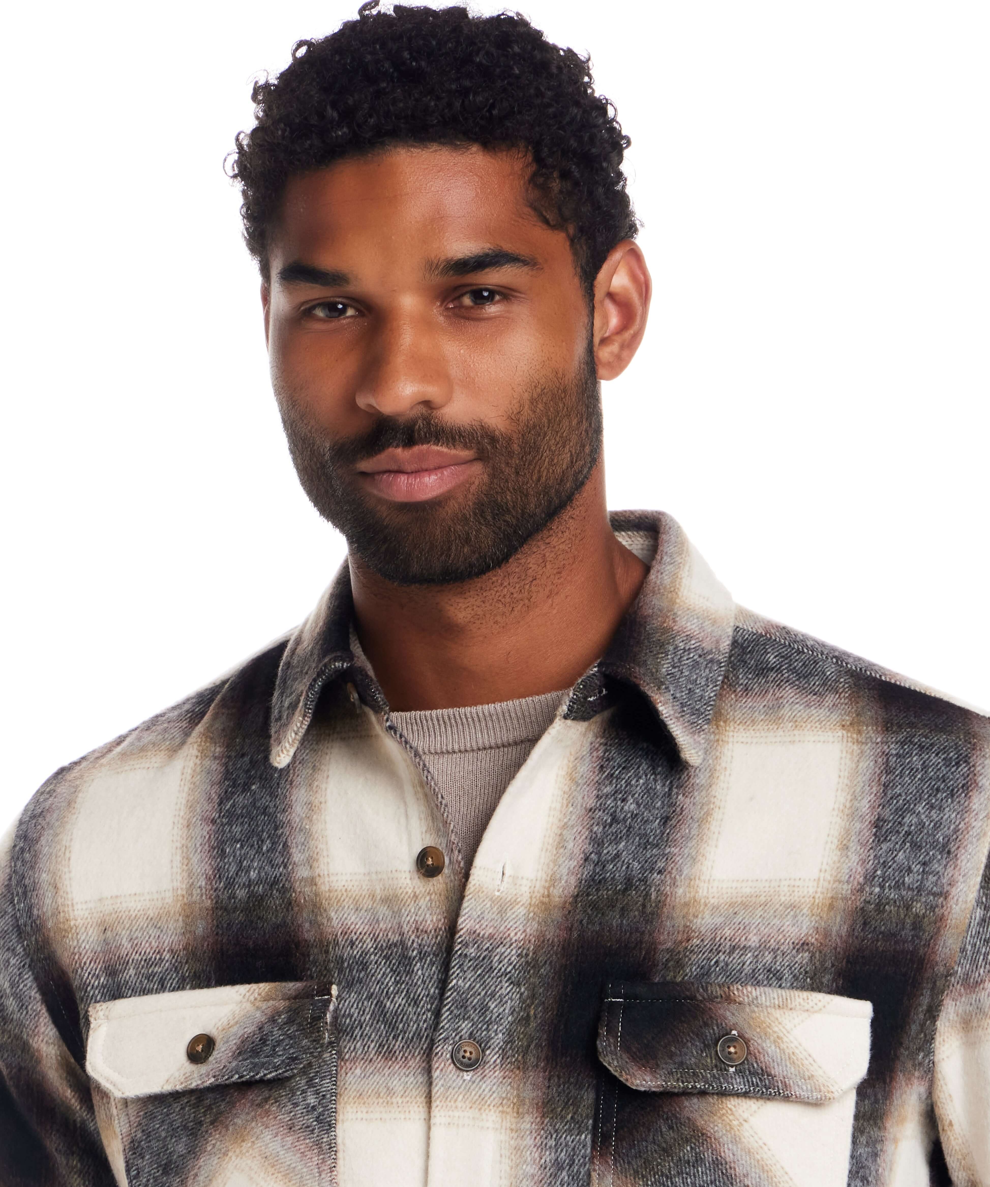 Brushed Unlined Plaid Shirt Jacket in Chocolate Cream modeled by a man with curly hair, featuring a classic plaid design.
