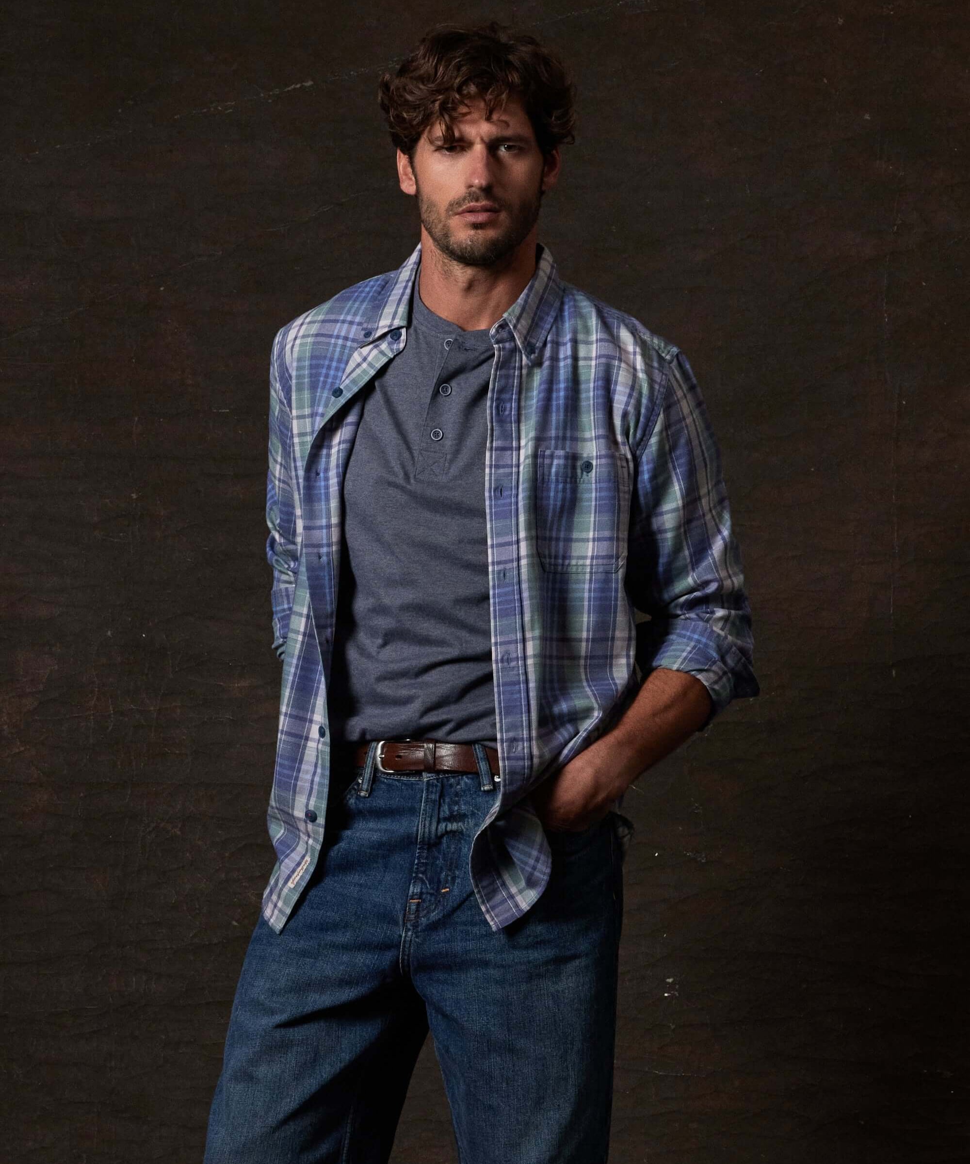Model wearing Long Sleeve Burnout Flannel in Dutch Blue layered over a gray shirt, showing casual style.