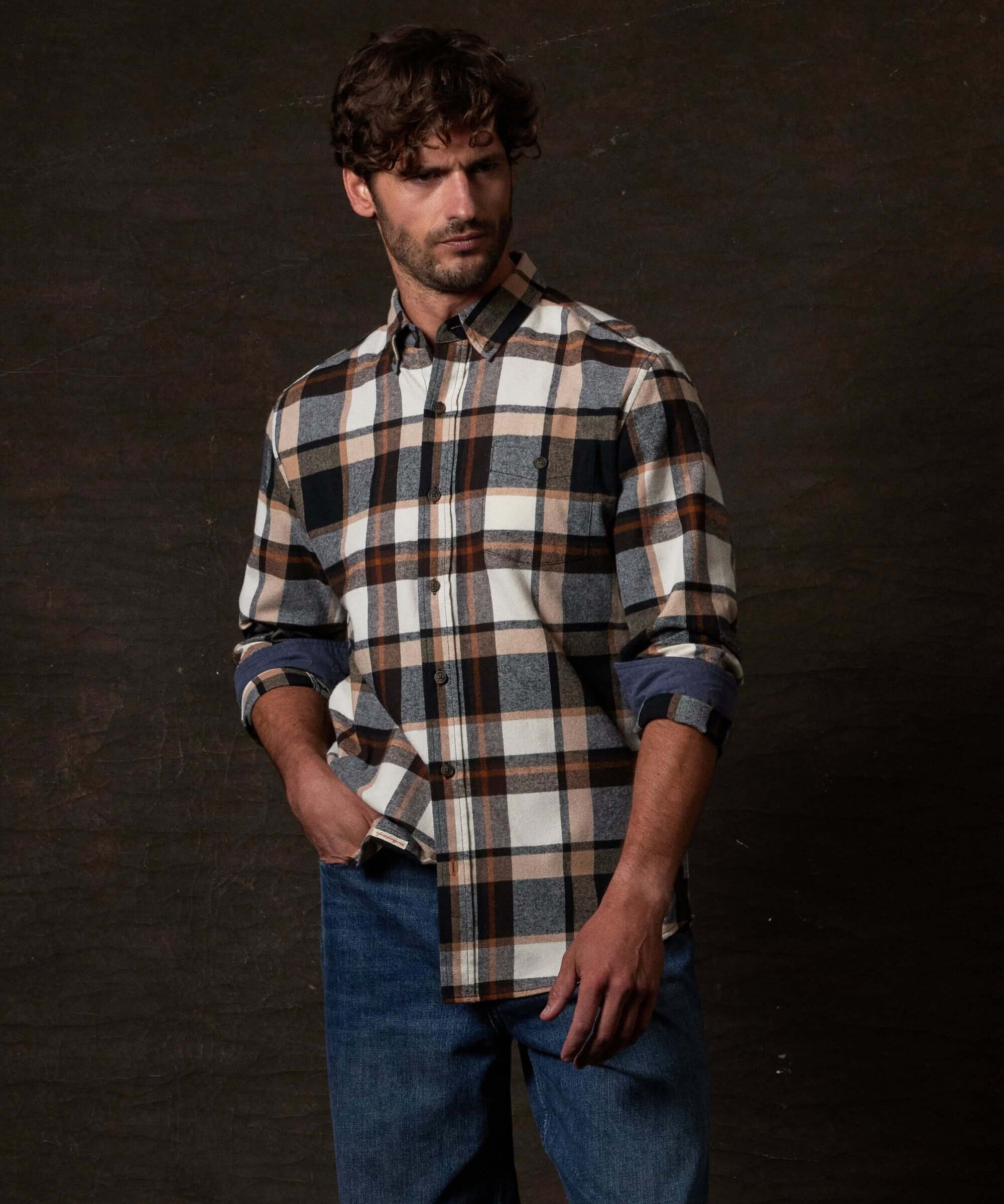 Long Sleeve Brushed Flannel in Caramel Cafe modeled by a man, featuring a rugged plaid design and button-down collar.