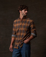 Long Sleeve Brushed Flannel in Pumpkin Spice worn by a man styled with jeans and set against a dark background.