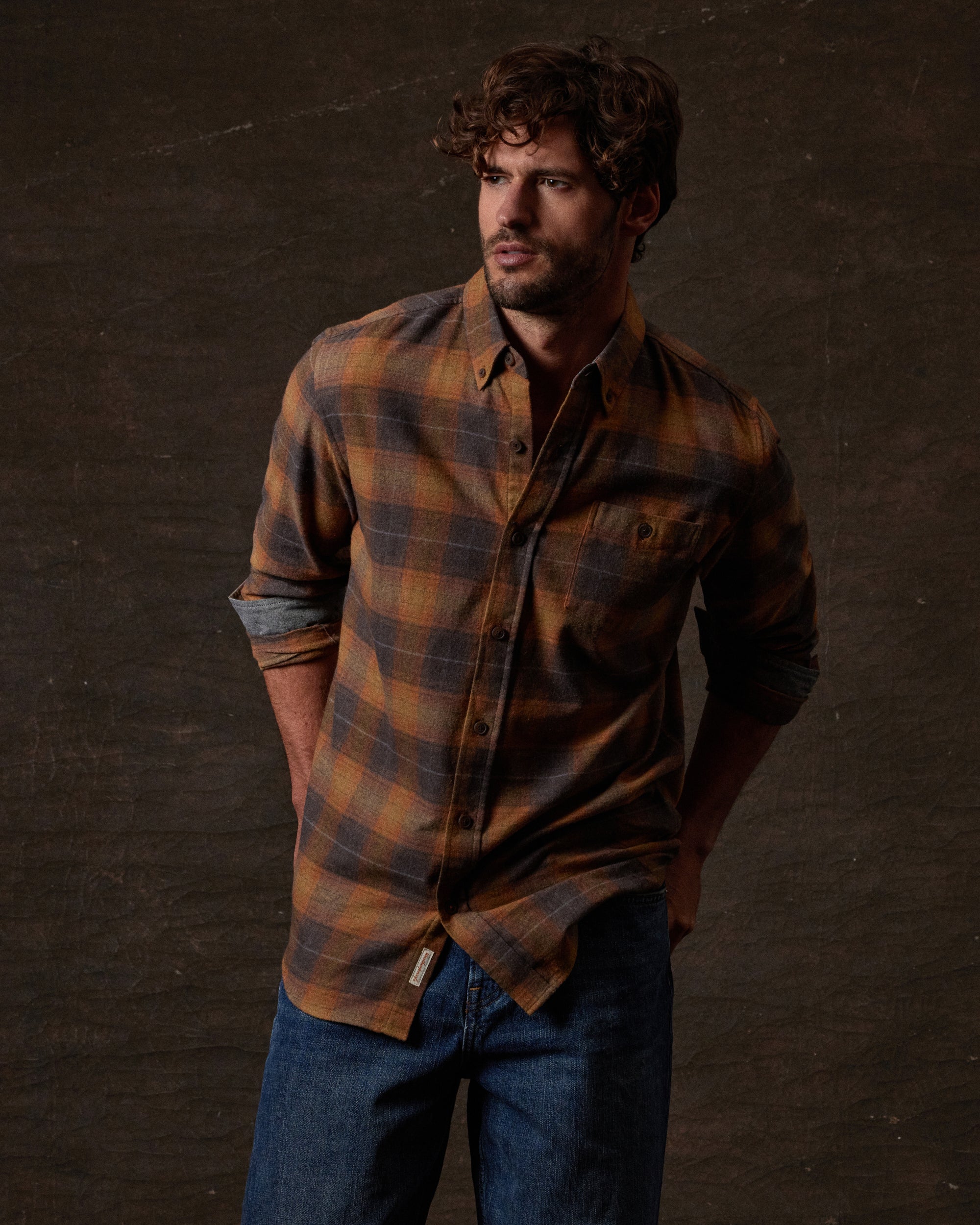 Long Sleeve Brushed Flannel in Pumpkin Spice modeled by man with curly hair, featuring a button-down collar.
