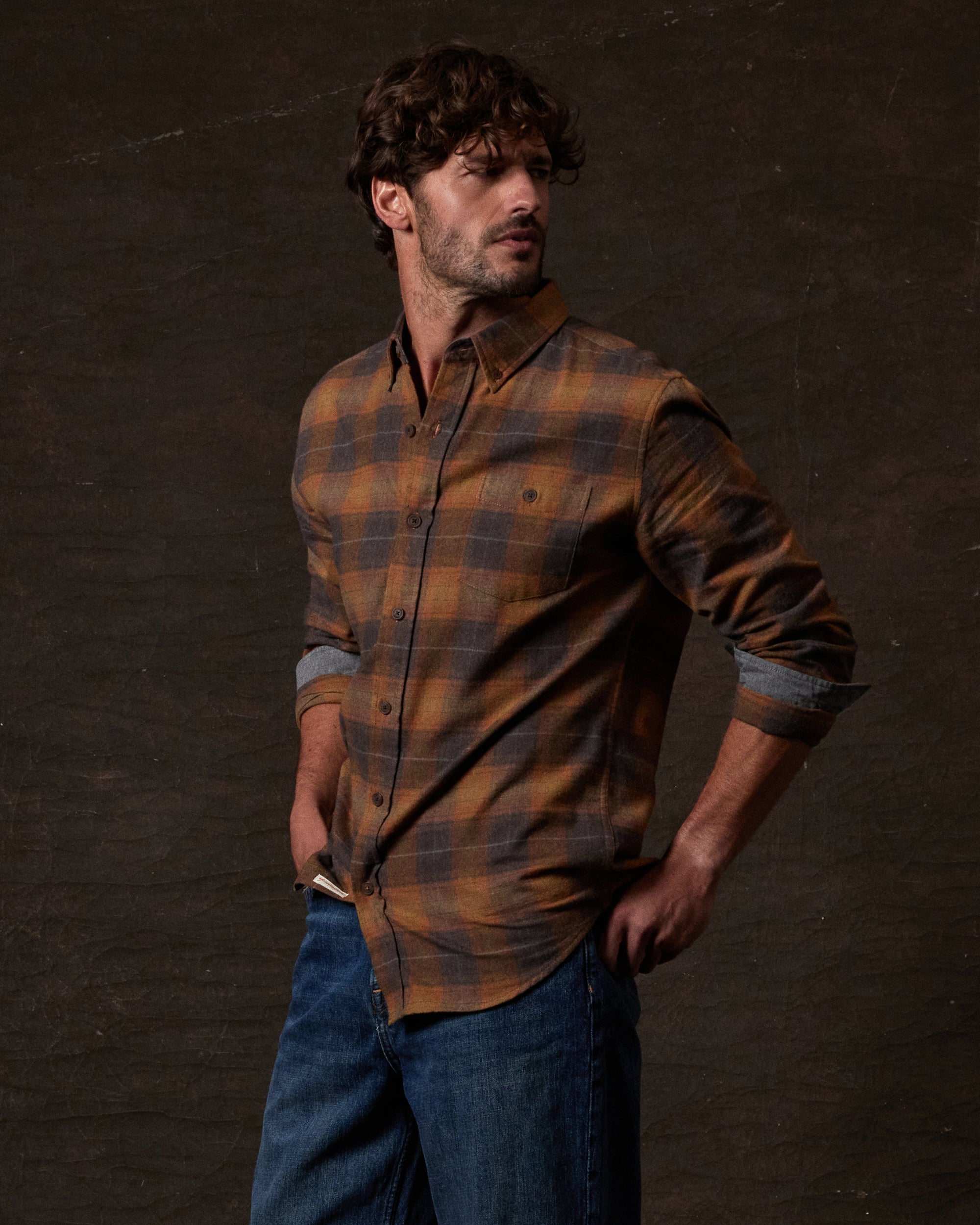 Model wearing Long Sleeve Brushed Flannel in Pumpkin Spice, showcasing a rugged, vintage style with a button-down collar.