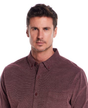 Long Sleeve Pebble Corduroy Shirt in Syrah worn by a model, featuring a button-down collar and single chest pocket.