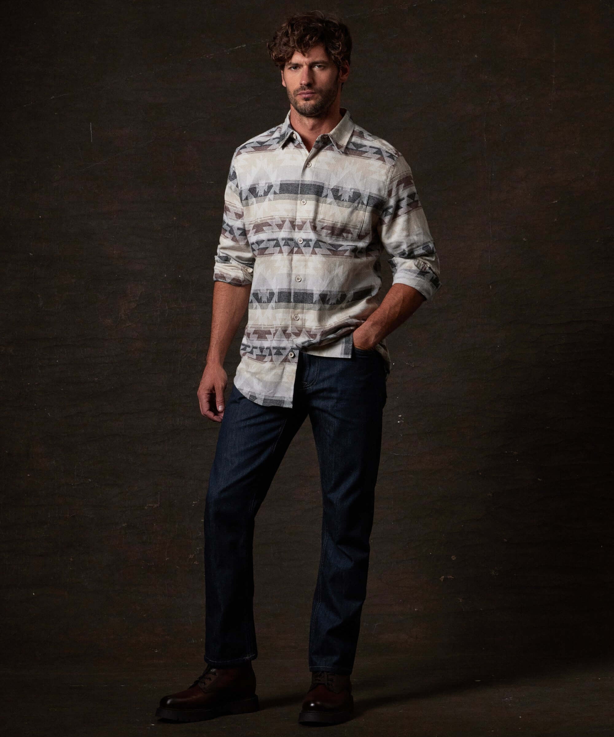 Model wearing Southwest Unlined Jacquard Over-shirt in Seed Pearl with denim and boots against a dark background.
