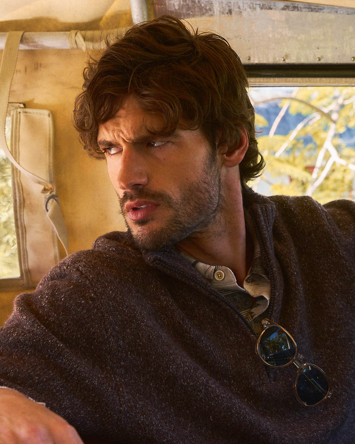 Fuzzy Quarter Zip Sweater in Brown worn by a man sitting inside a vintage vehicle.