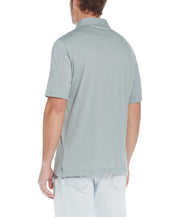 Back view of a man wearing the Mini Stripe Polo In Four Leaf Clover, showcasing the soft jersey fabric.