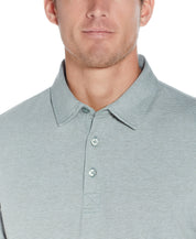Model wearing a Mini Stripe Polo In Four Leaf Clover featuring a fold down collar and button placket.