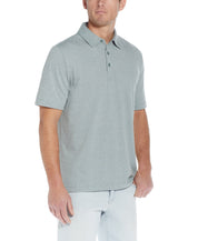 Mini Stripe Polo In Four Leaf Clover showcased on a model with short sleeves and a fold-down collar.