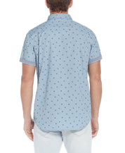 Back view of Poplin Seashell Printed Shirt In Dusty Blue with seashell print and short sleeves.