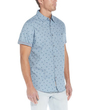 Poplin Seashell Printed Shirt In Dusty Blue worn by a model, showcasing a fun seashell print and chambray details.