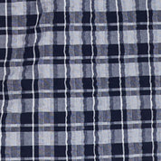 Plaid Seersucker Shirt In Shadow fabric close-up with navy and gray stripes showcasing a textured design.