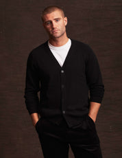 Model wearing a black cashmere cardigan over a white tee, showcasing soft and warm lightweight layering perfect for autumn.