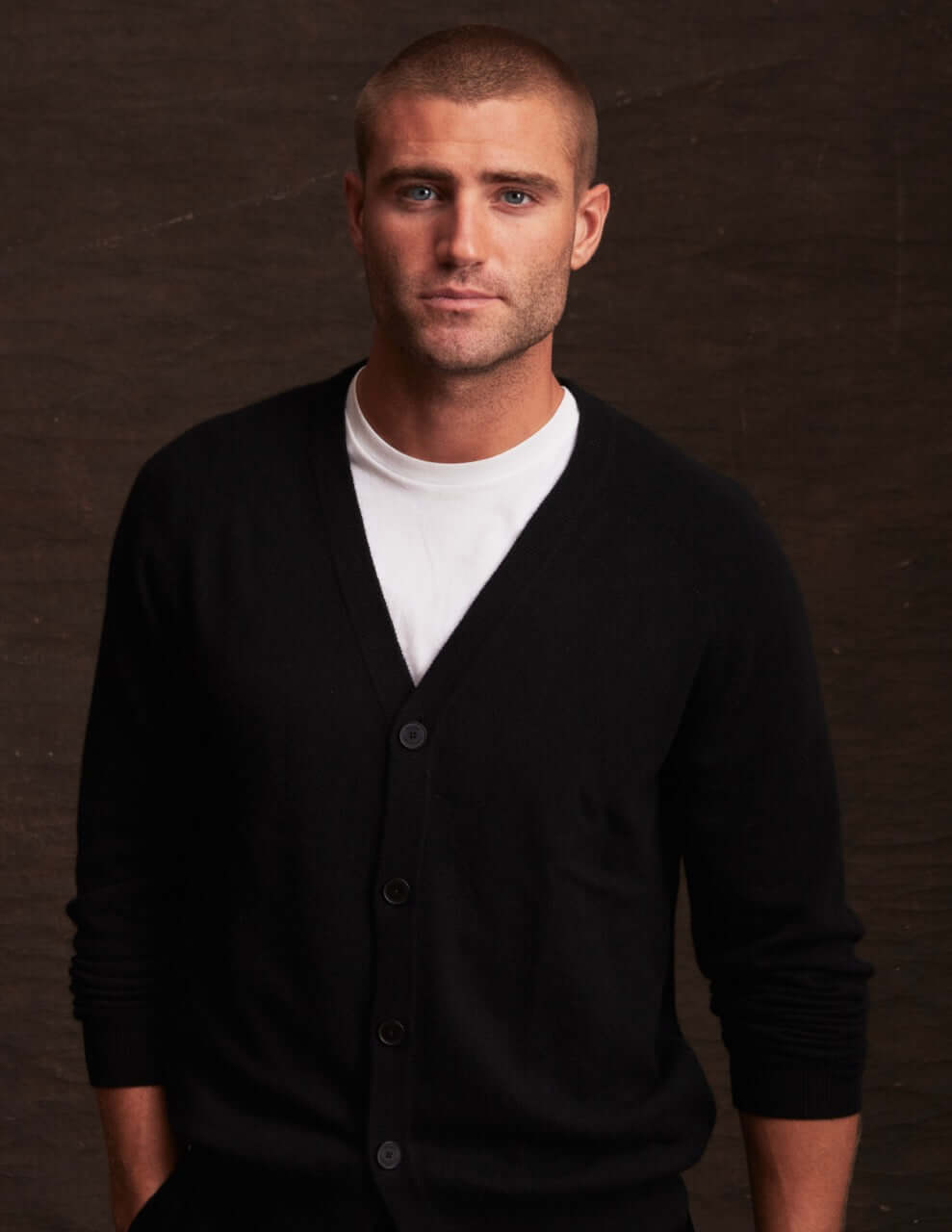 Man wearing a stylish black cashmere cardigan, perfect for layering in autumn and winter.