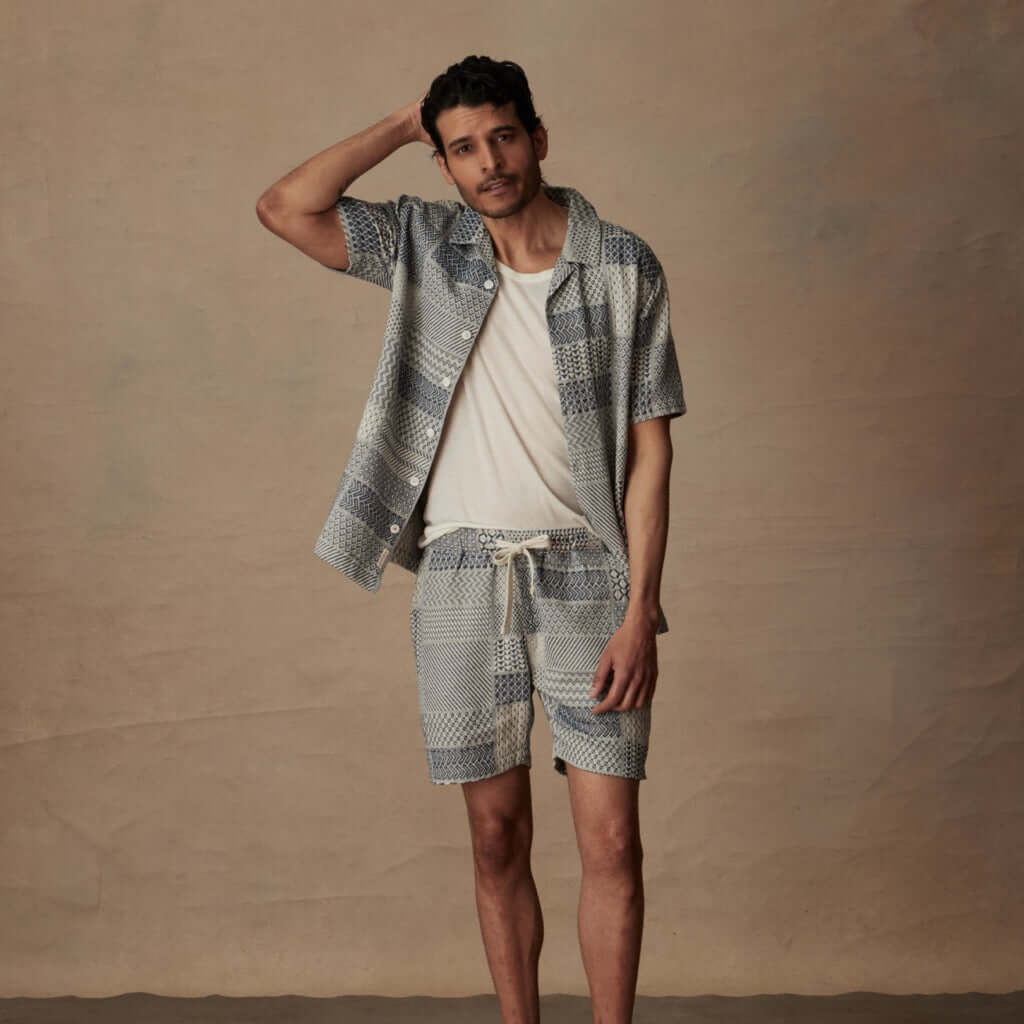 Model wearing a Jacquard Resort Shirt in Cream/Navy paired with matching shorts, ideal for relaxed vacation style.