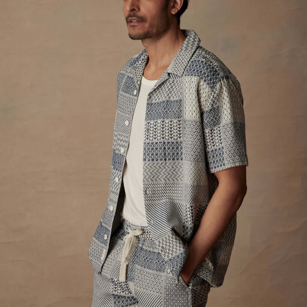 Model wearing Cream/Navy Jacquard Resort Shirt, showcasing retro charm and textured fabric, perfect for vacation style.