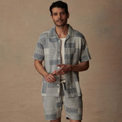 Model wearing Jacquard Resort Shirt in Cream/Navy, showcasing retro style and textured fabric, paired with matching shorts.