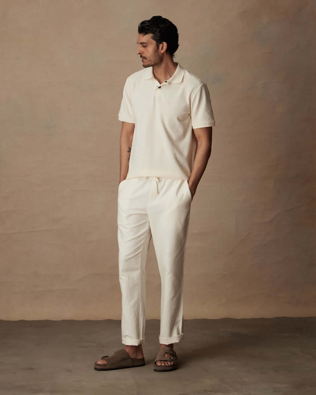 Model wearing white linen blend drawstring pants with a polo shirt, highlighting a relaxed fit and casual style.