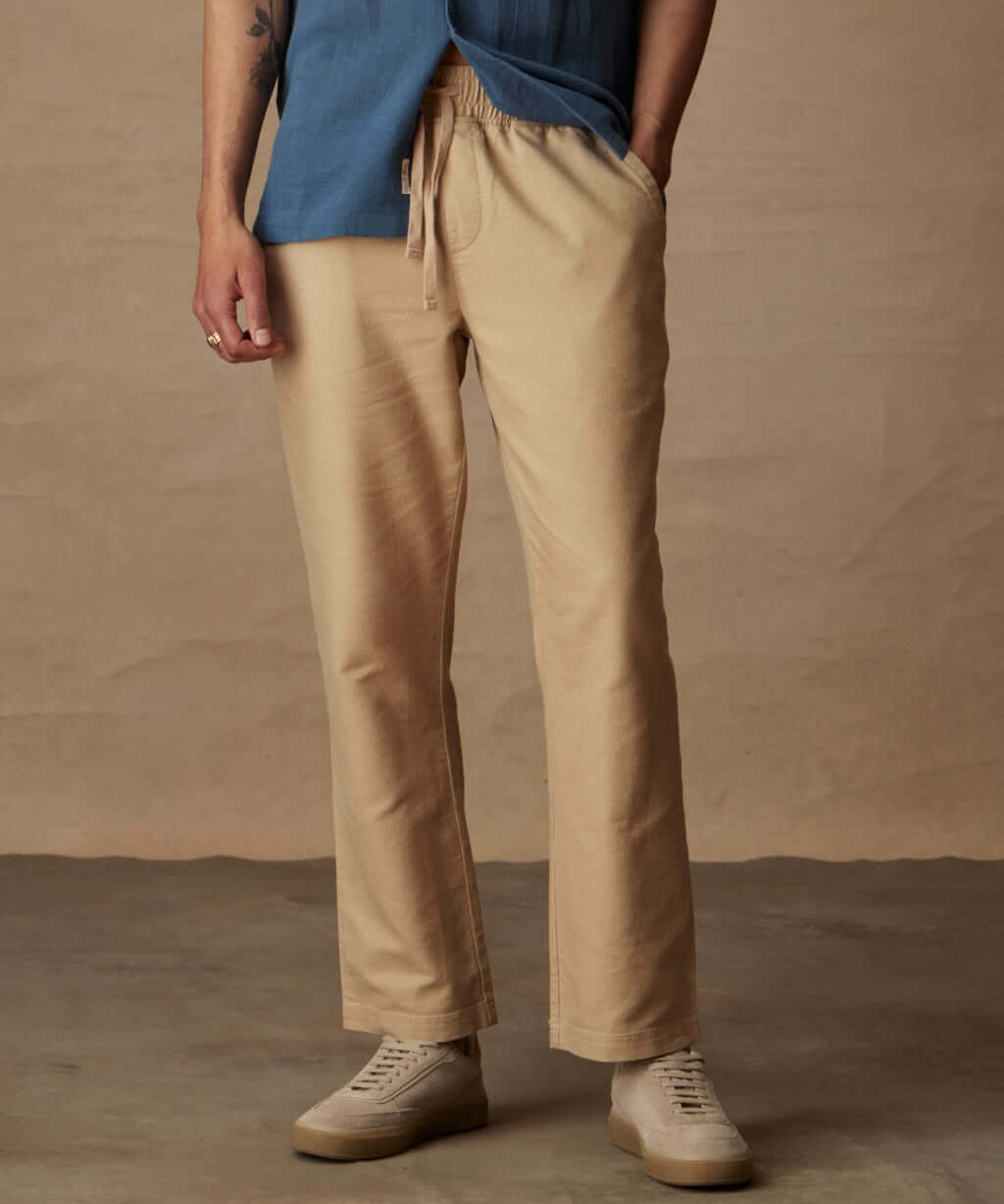 Linen blend drawstring pants in white pepper, featuring elastic waist and side pockets, modeled with a blue shirt.