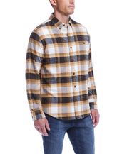 Man wearing a long sleeve brushed flannel shirt in antelope with a plaid pattern, ideal for layering and a classic look.