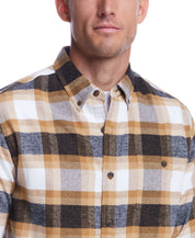 Man wearing Long Sleeve Brushed Flannel shirt in Antelope with a plaid pattern and button-down collar.