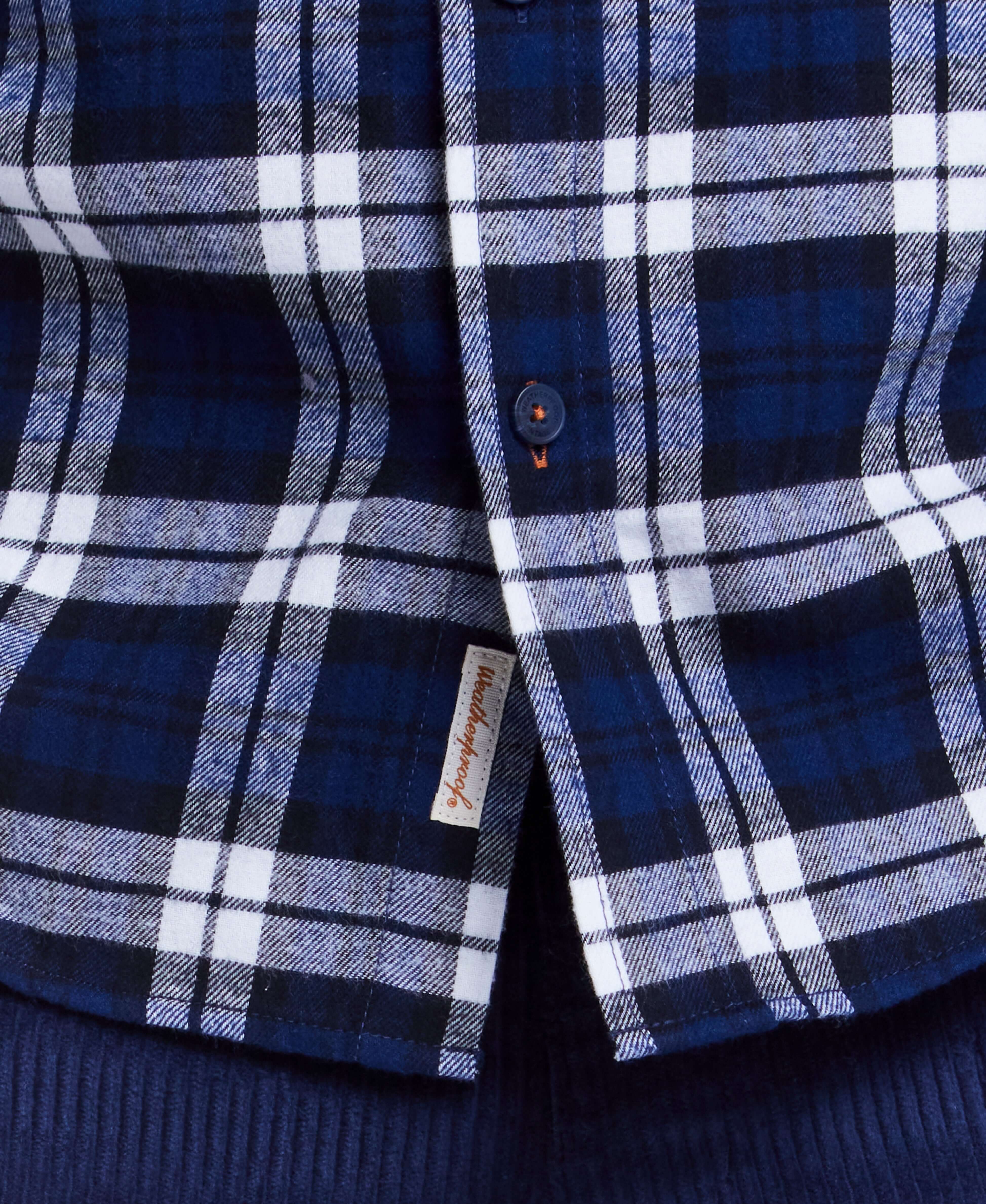 Close-up of blue plaid flannel shirt featuring button-down collar and breast pocket, ideal for rugged, rustic style.