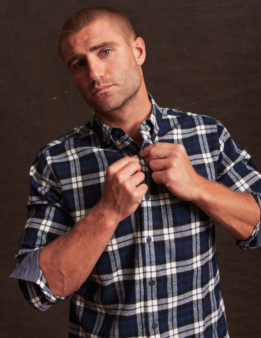 Man wearing a blue printed long sleeve brushed flannel shirt with a button-down collar and classic plaid pattern.
