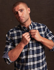 Man wearing a blue printed long sleeve brushed flannel shirt with a button-down collar and classic plaid pattern.