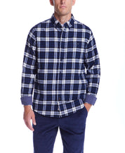 Model wearing a long sleeve blue print brushed flannel shirt with a classic plaid pattern and button-down collar.